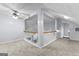 A carpeted bonus room/attic space with wood and white railing and ample sunlight at 11765 Fairway Overlook, Fayetteville, GA 30215