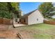 Backyard with wooden deck, fenced perimeter, and grass area beneath mature trees at 11765 Fairway Overlook, Fayetteville, GA 30215