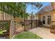 Outdoor patio area featuring overhead string lights, flowers, and a grill at 11765 Fairway Overlook, Fayetteville, GA 30215
