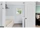 Bright bathroom featuring a bathtub and a large window at 11765 Fairway Overlook, Fayetteville, GA 30215