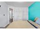 Well-lit bedroom features blue accent wall and two doors at 11765 Fairway Overlook, Fayetteville, GA 30215