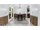 Dining room with decorative wainscoting and a view of the backyard through French doors at 11765 Fairway Overlook, Fayetteville, GA 30215