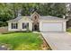 Charming single-story home with a two-car garage and manicured front lawn at 11765 Fairway Overlook, Fayetteville, GA 30215