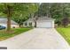 A beautiful home with a long concrete driveway and attached two car garage at 11765 Fairway Overlook, Fayetteville, GA 30215