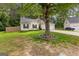 Charming home with black shutters and a beautiful, mature tree in the front yard at 11765 Fairway Overlook, Fayetteville, GA 30215
