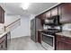 Modern kitchen with stainless steel appliances, granite countertops, and stylish cabinetry at 11765 Fairway Overlook, Fayetteville, GA 30215