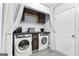 Laundry area featuring modern appliances, overhead cabinets, and ample counter space at 11765 Fairway Overlook, Fayetteville, GA 30215