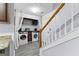 A laundry room with washer and dryer units and granite countertop on one side at 11765 Fairway Overlook, Fayetteville, GA 30215