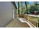 Wide view of a wooden deck attached to a home with mature trees in the background at 1226 Byewood Sw Ln, Atlanta, GA 30310