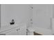 Bright bathroom featuring a white vanity, toilet, and a tiled shower/bathtub with a built-in shelf at 1226 Byewood Sw Ln, Atlanta, GA 30310