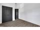 Empty bedroom with hardwood floors, dark closet doors, and neutral paint at 1226 Byewood Sw Ln, Atlanta, GA 30310