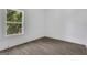 Minimalist bedroom featuring modern flooring, white walls, and a window with a leafy view at 1226 Byewood Sw Ln, Atlanta, GA 30310