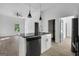 Modern kitchen features an island with black countertop and sleek black appliances in an open floor plan at 1226 Byewood Sw Ln, Atlanta, GA 30310