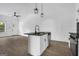 Modern kitchen features a central island with a sink, black countertop, and stainless steel appliances at 1226 Byewood Sw Ln, Atlanta, GA 30310