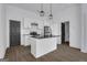 Modern kitchen featuring white cabinets, black countertops, stainless steel appliances, and hardwood floors at 1226 Byewood Sw Ln, Atlanta, GA 30310