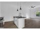 Bright open floor plan features modern island kitchen with stone counters and luxury vinyl plank flooring at 1226 Byewood Sw Ln, Atlanta, GA 30310