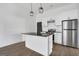 Contemporary kitchen featuring white cabinets, black countertops, stainless steel appliances, and hardwood floors at 1226 Byewood Sw Ln, Atlanta, GA 30310