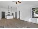 Spacious living room with hardwood floors, a ceiling fan, and a view of the kitchen at 1226 Byewood Sw Ln, Atlanta, GA 30310