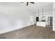 Large living area with hardwood floors, a ceiling fan, and a door leading to another room at 1226 Byewood Sw Ln, Atlanta, GA 30310