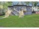 Gray home featuring a lush lawn and two sets of wooden stairs leading to elevated entrances at 1226 Byewood Sw Ln, Atlanta, GA 30310
