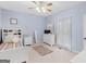 Cozy bedroom with light blue walls, white furniture, and a ceiling fan at 507 N Green Cir, Mcdonough, GA 30252