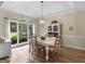 Light and bright dining room featuring a large bay window and a modern chandelier at 507 N Green Cir, Mcdonough, GA 30252