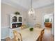 Well-lit dining room showcasing a stylish chandelier and a charming hutch for storage and display at 507 N Green Cir, Mcdonough, GA 30252