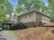 Exterior of a two-story home featuring a brick facade, vinyl siding, and lush landscaping at 507 N Green Cir, Mcdonough, GA 30252