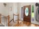 Inviting foyer with wood floors, staircase, and a glass-accented front door providing lots of natural light at 507 N Green Cir, Mcdonough, GA 30252