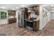 Kitchen featuring stainless steel appliances, granite countertops, dark wood cabinetry, and wood look flooring at 507 N Green Cir, Mcdonough, GA 30252