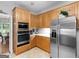 Spacious kitchen features stainless steel appliances, white countertops, and plenty of wooden cabinet space at 507 N Green Cir, Mcdonough, GA 30252