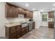 Kitchen featuring stainless steel appliances, granite countertops, dark wood cabinetry, and wood look flooring at 507 N Green Cir, Mcdonough, GA 30252