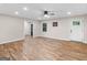 Spacious living room featuring light colored walls, wood look flooring, ceiling fan, and natural light at 507 N Green Cir, Mcdonough, GA 30252