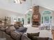 Open-concept living room features a stone fireplace, vaulted ceiling, and comfortable seating at 507 N Green Cir, Mcdonough, GA 30252