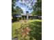 Spacious backyard featuring a patio, sun room, lush greenery and mature trees, perfect for outdoor enjoyment at 5639 Mallard Trl, Lithonia, GA 30058