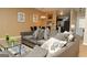 Open-concept living room with neutral tones, artwork, and access to kitchen with stainless steel appliances at 5639 Mallard Trl, Lithonia, GA 30058