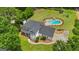 Beautiful aerial view of home featuring in-ground pool, ample lawn and driveway at 140 Laurel Lake Rd, Tyrone, GA 30290