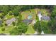 Aerial view of residences featuring a lush treed landscape, a home, and in-ground pool at 140 Laurel Lake Rd, Tyrone, GA 30290