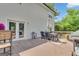 Outdoor dining on the back deck, featuring a table with umbrella and grill at 140 Laurel Lake Rd, Tyrone, GA 30290