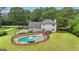 An in-ground pool in a well-maintained lawn adds recreational space to this charming home at 140 Laurel Lake Rd, Tyrone, GA 30290