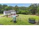 Spacious backyard boasts a pool, playground, trampoline, and expansive lawn at 140 Laurel Lake Rd, Tyrone, GA 30290