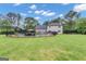 Expansive backyard featuring a swimming pool, privacy fence, and lush green lawn, perfect for outdoor activities at 140 Laurel Lake Rd, Tyrone, GA 30290