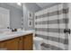Neat bathroom featuring a single vanity, a striped shower curtain, and neutral tones at 140 Laurel Lake Rd, Tyrone, GA 30290