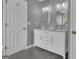 Stylish bathroom with double vanity, marble countertop, round mirrors, and ample storage space at 140 Laurel Lake Rd, Tyrone, GA 30290