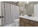 Comfortable bathroom featuring patterned shower curtain, single vanity and neutral tones at 140 Laurel Lake Rd, Tyrone, GA 30290