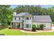 Charming two-story home with a covered front porch, detailed trim, and a well-maintained lawn at 140 Laurel Lake Rd, Tyrone, GA 30290