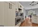Updated kitchen featuring stainless steel appliances, white cabinets, and hardwood floors at 140 Laurel Lake Rd, Tyrone, GA 30290