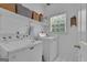 Well-organized laundry room equipped with a washer, dryer, and shelving for storage at 140 Laurel Lake Rd, Tyrone, GA 30290