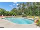 Sparkling in-ground pool with surrounding lounge chairs and a lush green backyard at 140 Laurel Lake Rd, Tyrone, GA 30290