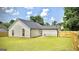 The backyard features lush green grass, new fencing, and the rear exterior of the home at 6638 Creek Turn Dr, Rex, GA 30273